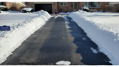 Cleared residential driveway after professional snow removal by Chop Chop Landscaping in Oak Park, IL