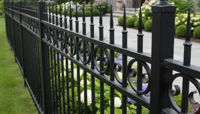 Ornamental black metal fence with decorative details by Chop Chop Landscaping in Oak Park, IL